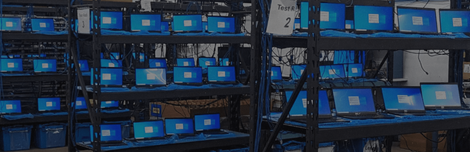 Image of rows and rows of refurbished laptop computers being tested for an order.