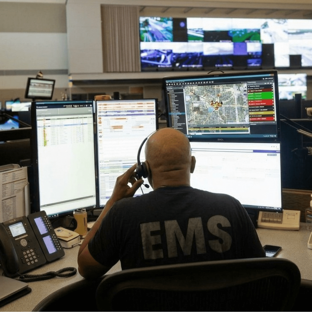 Image of Dell Computer Monitors being used by a 911 dispatch operator.