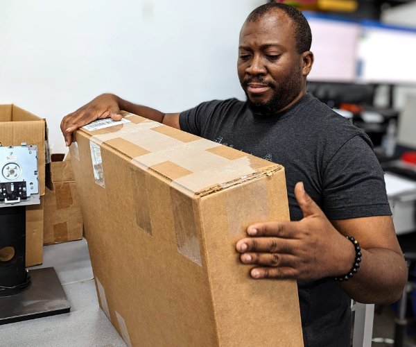 Evergreen Electronics, Inc. employee packing up a customer order for shipment.