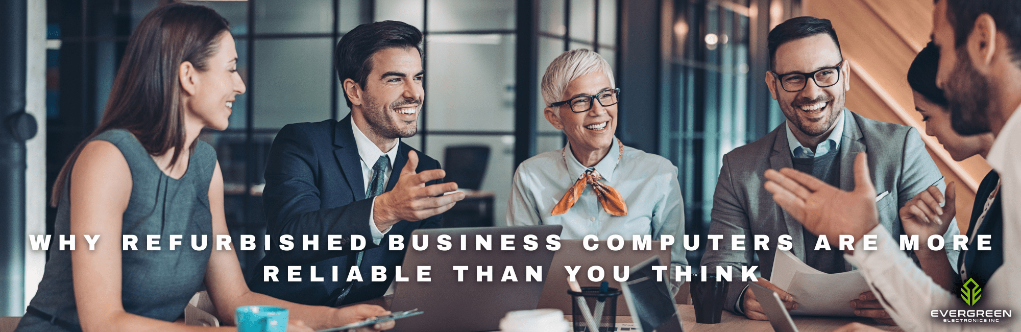 Business professionals sitting around a conference table smiling and discussing work with laptops and documents, with the headline “Why Refurbished Business Computers Are More Reliable Than You Think” displayed across the image.